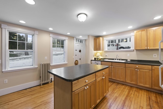37 Central St, Hallowell, ME 04347 - kitchen with radiator, light wood finished floors, dark countertops, a kitchen island, and recessed lighting