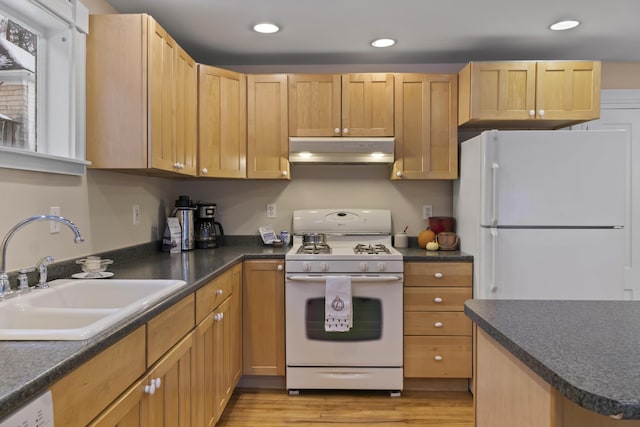 37 Central St, Hallowell, ME 04347 - kitchen with white appliances, under cabinet range hood, dark countertops, light wood-style floors, and recessed lighting