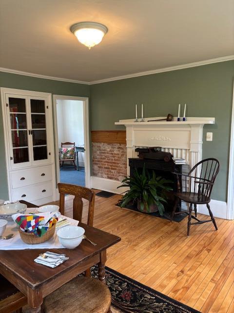 37 Central St, Hallowell, ME 04347 - living room featuring wood finished floors, a fireplace with flush hearth, and ornamental molding