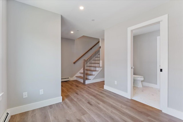 50 Ocean Park Rd Unit 102, Saco, ME 04072 - unfurnished living room with a baseboard radiator, recessed lighting, stairway, and wood finished floors