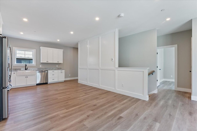 50 Ocean Park Rd Unit 102, Saco, ME 04072 - kitchen with stainless steel appliances, open floor plan, white cabinetry, light wood-type flooring, and recessed lighting
