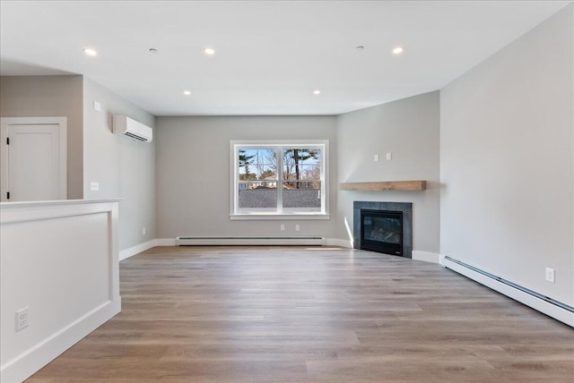 50 Ocean Park Rd Unit 102, Saco, ME 04072 - unfurnished living room featuring a wall mounted AC, a baseboard heating unit, a glass covered fireplace, baseboard heating, and recessed lighting