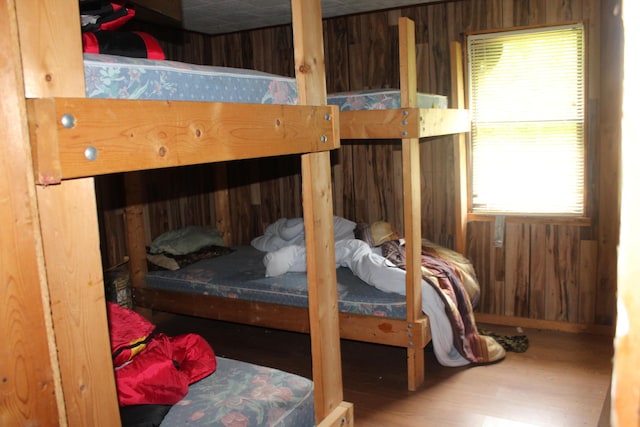 1100 Shin Pond Rd, Mount Chase, ME 04765 - bedroom featuring multiple windows, wood finished floors, and wood walls