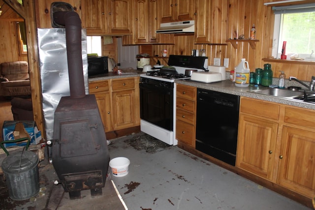 1100 Shin Pond Rd, Mount Chase, ME 04765 - kitchen with dishwasher, a wood stove, gas range oven, under cabinet range hood, and wooden walls