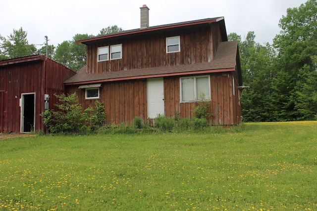 1100 Shin Pond Rd, Mount Chase, ME 04765 - back of property with a lawn, roof with shingles, and a chimney