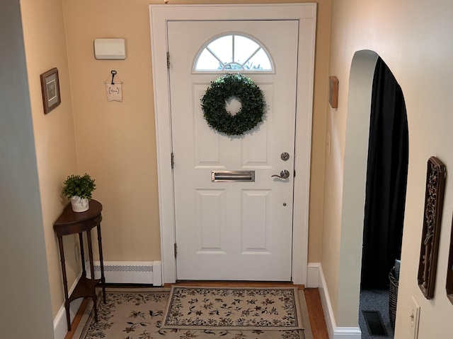 8 Kling St, Augusta, ME 04330 - foyer entrance featuring a baseboard heating unit and wood finished floors