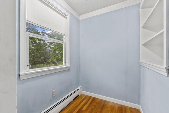 28 Colony Rd, Augusta, ME 04330 - spare room featuring a baseboard heating unit, wood finished floors, and a textured ceiling