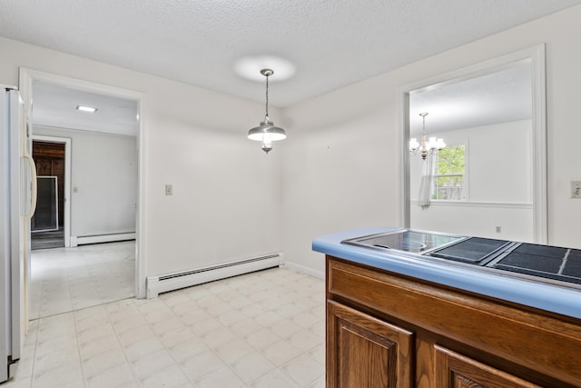 28 Colony Rd, Augusta, ME 04330 - kitchen featuring baseboard heating, freestanding refrigerator, light flooring, brown cabinetry, and a textured ceiling