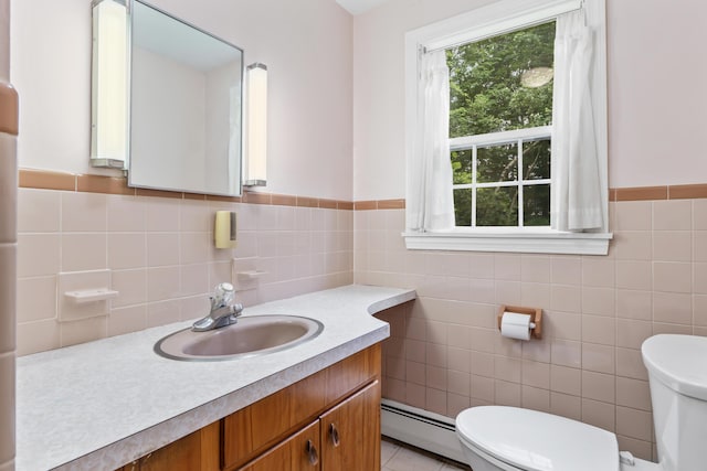 28 Colony Rd, Augusta, ME 04330 - bathroom featuring a baseboard radiator, vanity, tile walls, and a wainscoted wall
