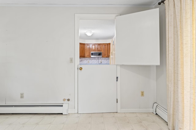28 Colony Rd, Augusta, ME 04330 - laundry room featuring baseboard heating and light floors