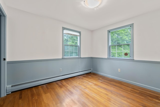28 Colony Rd, Augusta, ME 04330 - empty room with a baseboard heating unit and wood finished floors