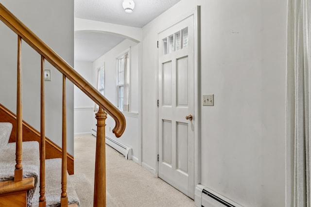 28 Colony Rd, Augusta, ME 04330 - entrance foyer with arched walkways, a baseboard radiator, carpet floors, and stairway