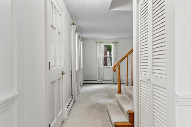 28 Colony Rd, Augusta, ME 04330 - corridor featuring a textured ceiling, stairs, a baseboard heating unit, light carpet, and a baseboard radiator