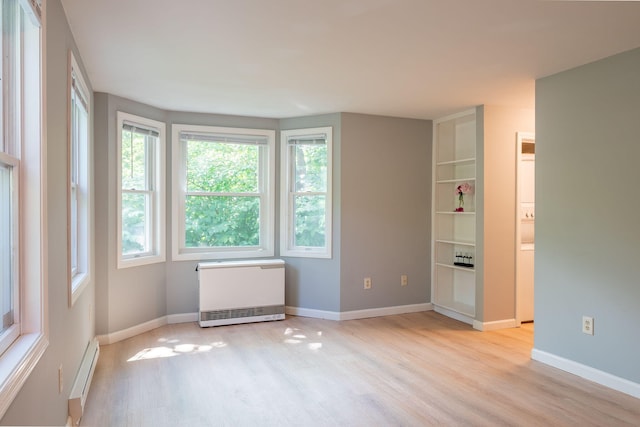 459 Allen Ave Unit 5, Portland, ME 04103 - unfurnished bedroom with light wood-type flooring, radiator heating unit, and baseboard heating