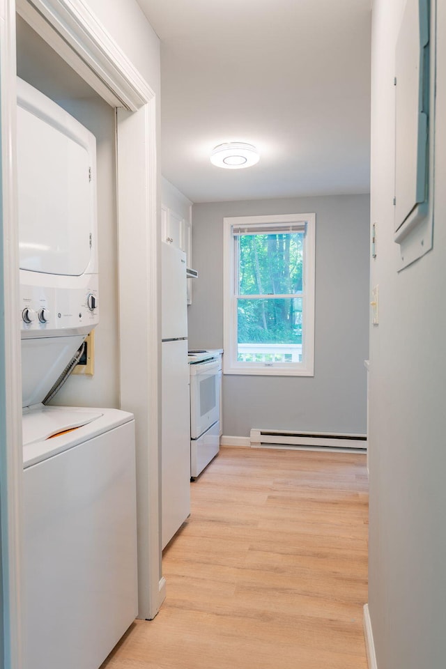 459 Allen Ave Unit 5, Portland, ME 04103 - washroom featuring estacked washer and dryer, a baseboard radiator, and light wood-style floors