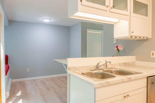 459 Allen Ave Unit 5, Portland, ME 04103 - kitchen with light wood-type flooring, dishwasher, a peninsula, light countertops, and glass insert cabinets