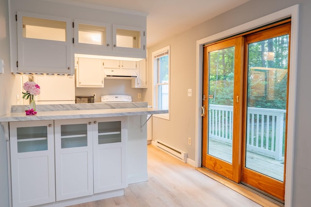 459 Allen Ave Unit 5, Portland, ME 04103 - kitchen featuring baseboard heating, under cabinet range hood, light countertops, and light wood-type flooring