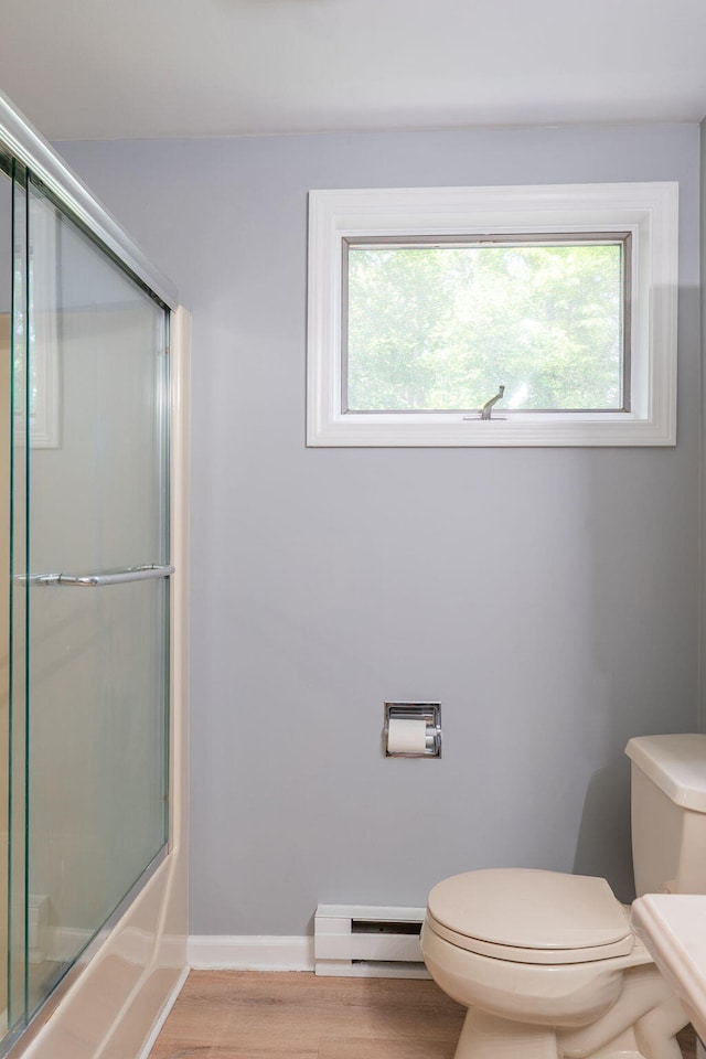 459 Allen Ave Unit 5, Portland, ME 04103 - bathroom featuring baseboard heating, healthy amount of natural light, wood finished floors, and bath / shower combo with glass door