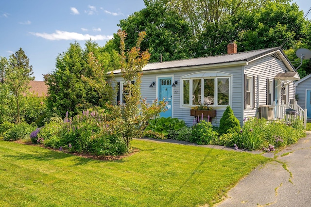 212 Lincoln St, Bangor, ME 04401 - view of front of property with a chimney, a front lawn, and a metal roof