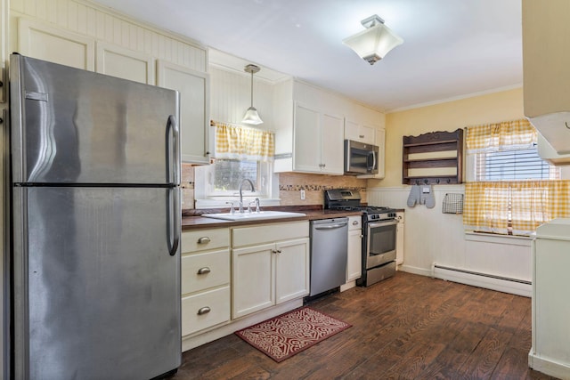 212 Lincoln St, Bangor, ME 04401 - kitchen featuring stainless steel appliances, crown molding, dark countertops, baseboard heating, and dark wood finished floors