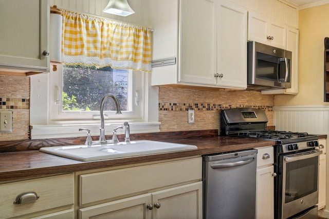 212 Lincoln St, Bangor, ME 04401 - kitchen featuring stainless steel appliances, wood counters, and backsplash
