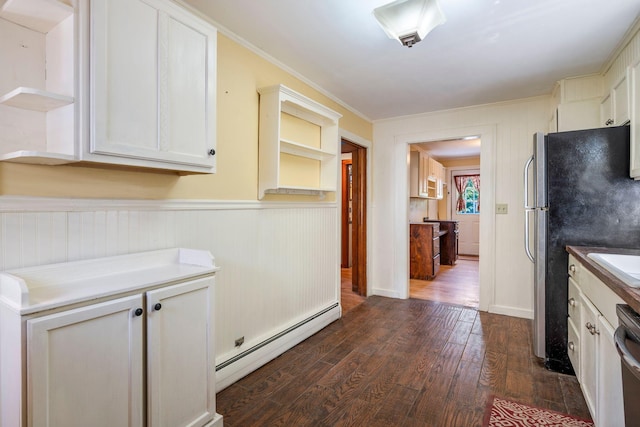 212 Lincoln St, Bangor, ME 04401 - kitchen with a baseboard radiator, dark wood finished floors, ornamental molding, freestanding refrigerator, and a wainscoted wall