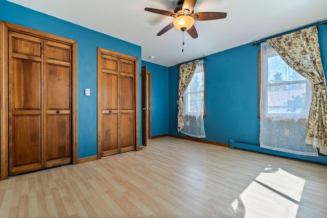 212 Lincoln St, Bangor, ME 04401 - unfurnished bedroom with light wood-style floors, multiple windows, two closets, and ceiling fan