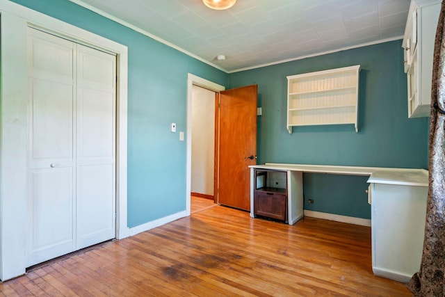 212 Lincoln St, Bangor, ME 04401 - unfurnished bedroom featuring ornamental molding, hardwood / wood-style flooring, and a closet