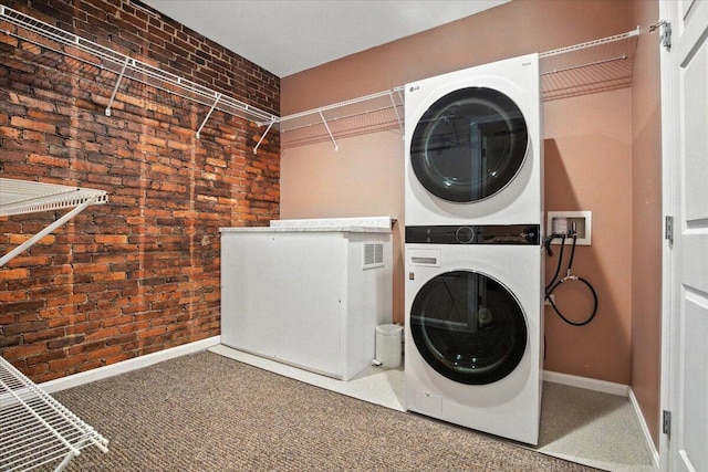 43 Lisbon St Unit 2B, Lewiston, ME 04240 - laundry area with estacked washer and dryer, brick wall, and carpet floors