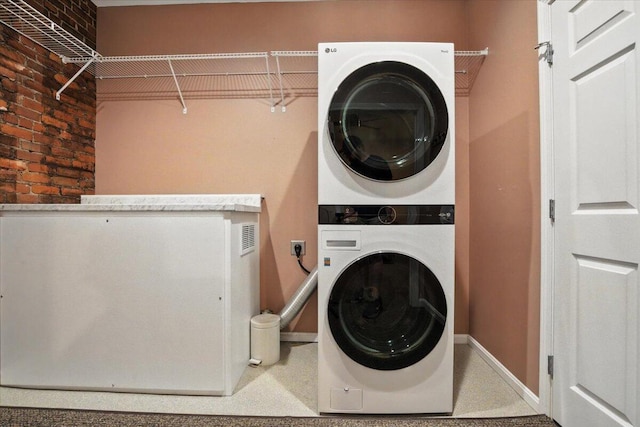 43 Lisbon St Unit 2B, Lewiston, ME 04240 - laundry room with stacked washer and clothes dryer and brick wall