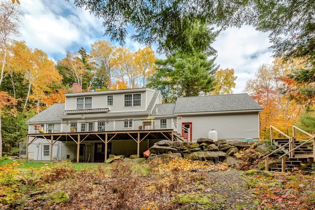 51 Tracy Cove Cir, Rome, ME 04963 - back of property with a deck, a chimney, stairs, and roof with shingles
