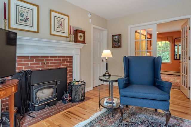 51 Tracy Cove Cir, Rome, ME 04963 - sitting room with wood finished floors, a baseboard heating unit, and a fireplace
