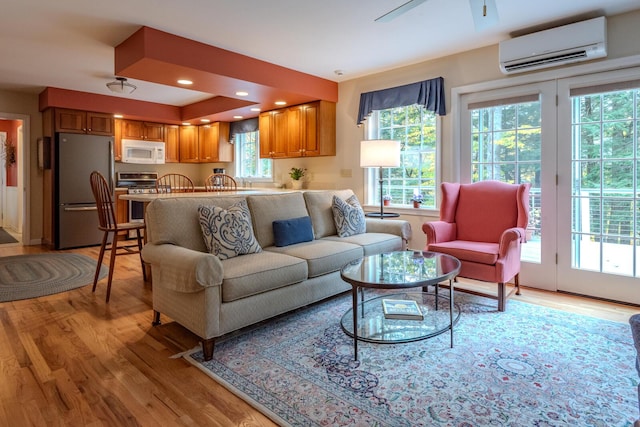 51 Tracy Cove Cir, Rome, ME 04963 - living room featuring a wall mounted AC, light wood-type flooring, and ceiling fan