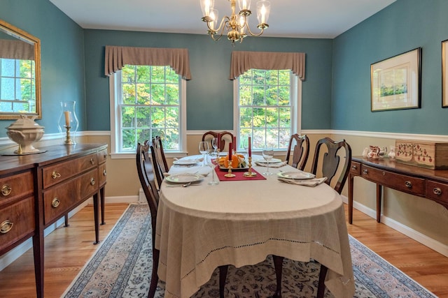 51 Tracy Cove Cir, Rome, ME 04963 - dining room with healthy amount of natural light, light wood finished floors, and a chandelier
