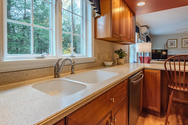 51 Tracy Cove Cir, Rome, ME 04963 - kitchen featuring brown cabinetry, a wall unit AC, dishwasher, wood finished floors, and recessed lighting