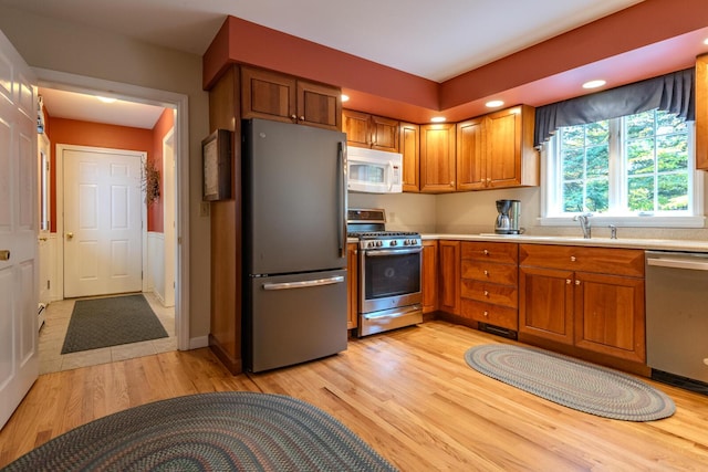 51 Tracy Cove Cir, Rome, ME 04963 - kitchen featuring appliances with stainless steel finishes, brown cabinets, light countertops, light wood-style flooring, and recessed lighting