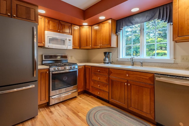51 Tracy Cove Cir, Rome, ME 04963 - kitchen with appliances with stainless steel finishes, light countertops, light wood-type flooring, brown cabinetry, and recessed lighting