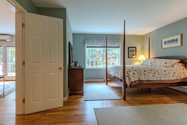 51 Tracy Cove Cir, Rome, ME 04963 - bedroom featuring a wall mounted AC, multiple windows, and wood finished floors