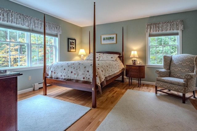 51 Tracy Cove Cir, Rome, ME 04963 - bedroom with baseboard heating, multiple windows, and wood finished floors