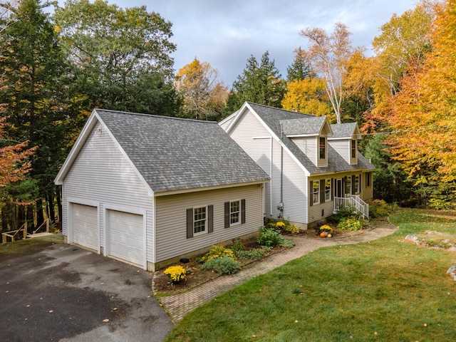 51 Tracy Cove Cir, Rome, ME 04963 - view of side of home with a shingled roof, a yard, asphalt driveway, and view of scattered trees