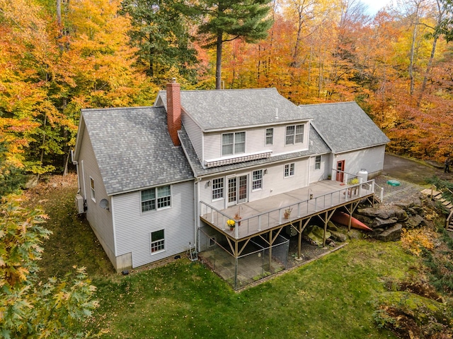 51 Tracy Cove Cir, Rome, ME 04963 - back of house with a deck, a chimney, a shingled roof, a lawn, and a view of trees