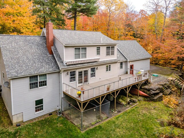 51 Tracy Cove Cir, Rome, ME 04963 - rear view of house with roof with shingles, a chimney, a deck, and a yard