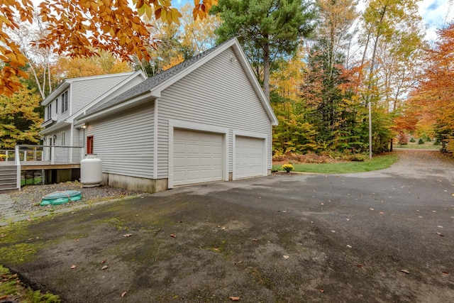 51 Tracy Cove Cir, Rome, ME 04963 - view of side of home featuring driveway, a garage, and a deck