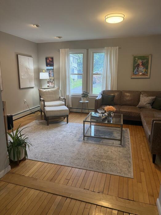 45 Tyler Ave, Bangor, ME 04401 - living room with a baseboard heating unit and hardwood / wood-style floors
