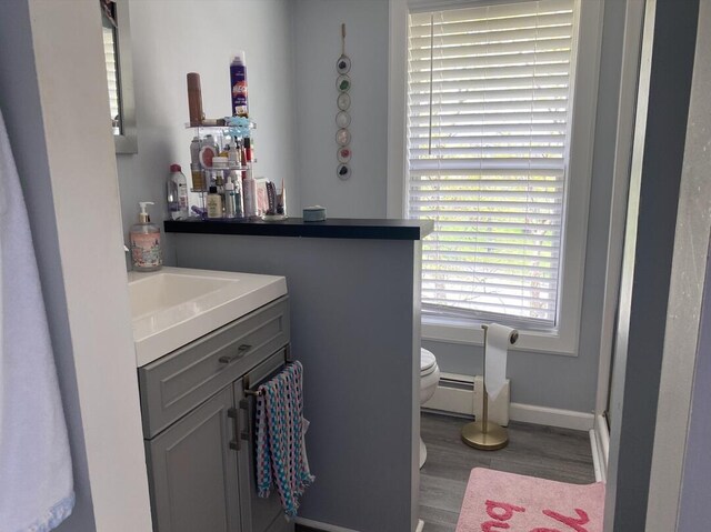 45 Tyler Ave, Bangor, ME 04401 - bathroom with vanity, wood finished floors, and a baseboard heating unit