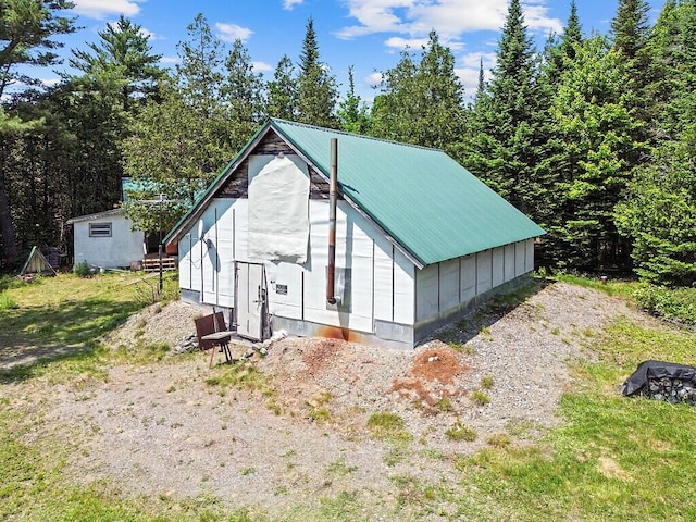 259 Drury Rd, Solon, ME 04979 - view of front facade with a metal roof and a storage unit