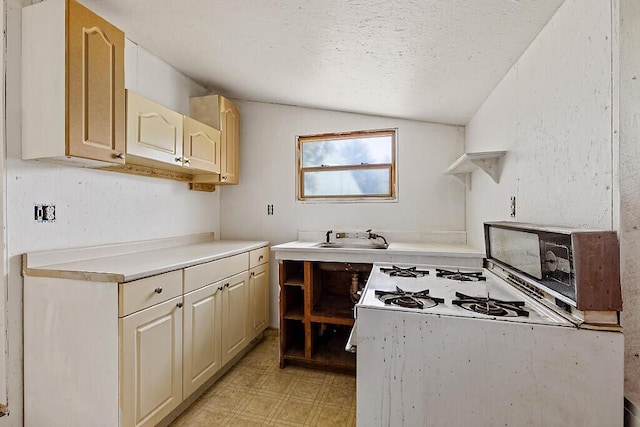 259 Drury Rd, Solon, ME 04979 - kitchen featuring white range with gas cooktop, light flooring, a textured ceiling, vaulted ceiling, and light countertops