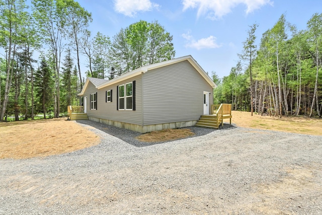 4 Willis Rd, Benton, ME 04901 - view of side of home with gravel driveway and a deck