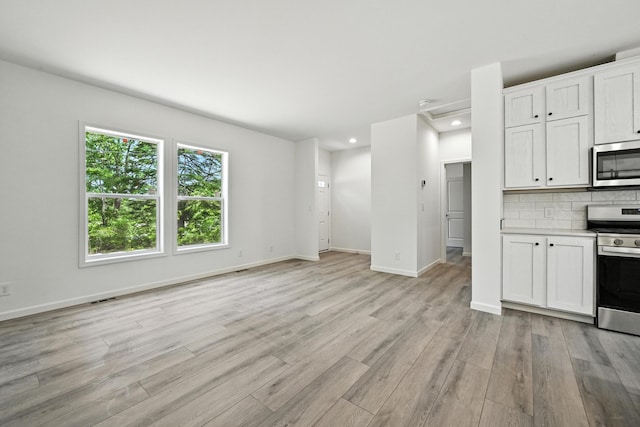 4 Willis Rd, Benton, ME 04901 - unfurnished living room with light wood-type flooring and recessed lighting