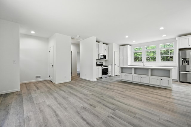 4 Willis Rd, Benton, ME 04901 - unfurnished living room with light wood finished floors and recessed lighting